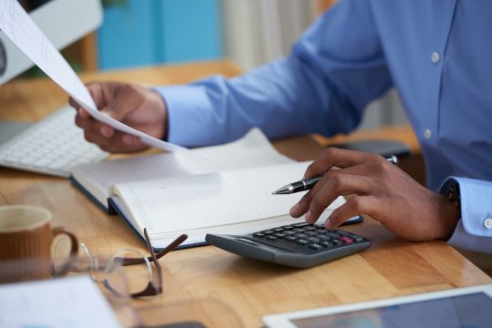 Close-up image of financial managers working with reports